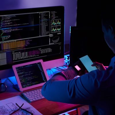 Programmer scanning screen on his smartwatch with smartphone camera